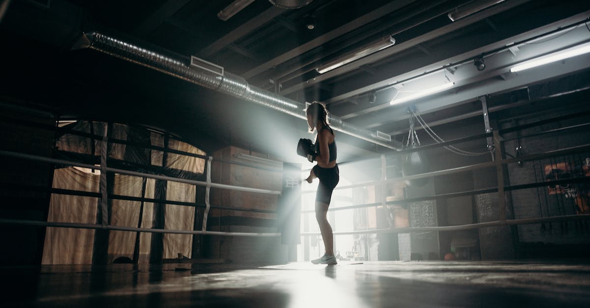 Will my own items' active make my champion cancel my current spell? - Woman in Black Tank Top and Black Shorts Standing on Brown Wooden Floor
