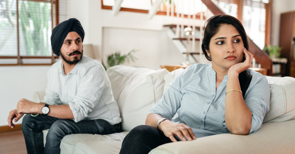 Will my spouse divorce me if I ignore them or pursue others? - Upset young Indian couple having argument while sitting on couch