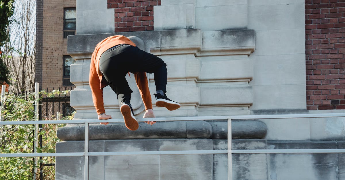 WIll powered rails make powered minecarts faster? - Back view full body of anonymous male athlete jumping over railing while performing parkour in city WIll powered rails make powered minecarts faster? - Back view full body of anonymous male athlete jumping over railing while performing parkour in city