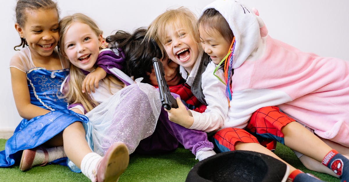 Will wearing special outfits during smile time affect a child? - Children Having Fun While Sitting on Green Carpet Wearing Different Costumes