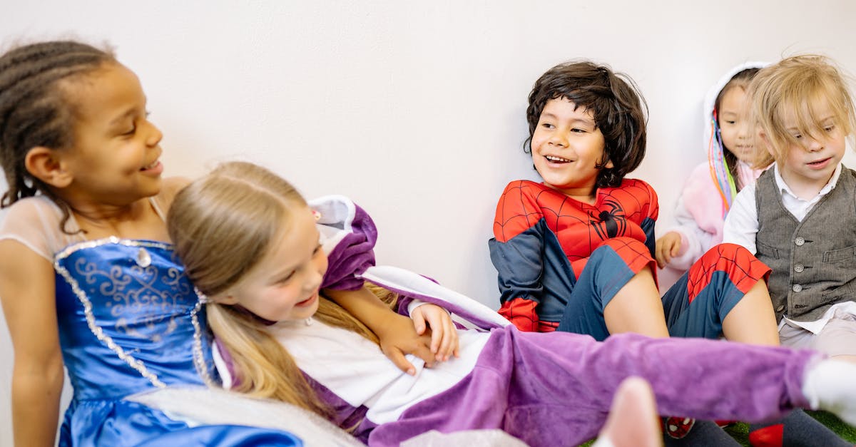 Will wearing special outfits during smile time affect a child? - Children Sitting On Green Carpet Wearing Different Costumes