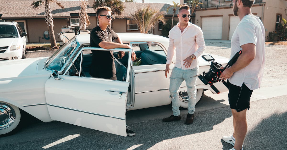 Windows 10 Video Driver Out-dated - Standing Man Wearing White Dress Shirt Beside Two Men and White Sedan