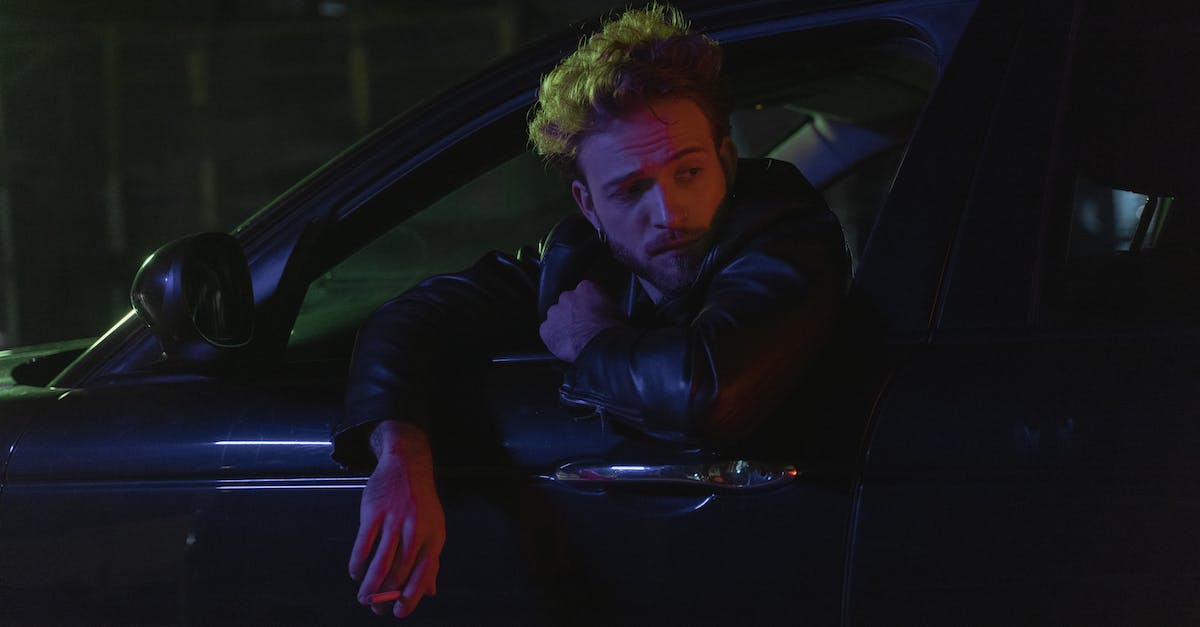 Windows 10 Video Driver Out-dated - Woman in Black Leather Jacket Sitting on Black Car