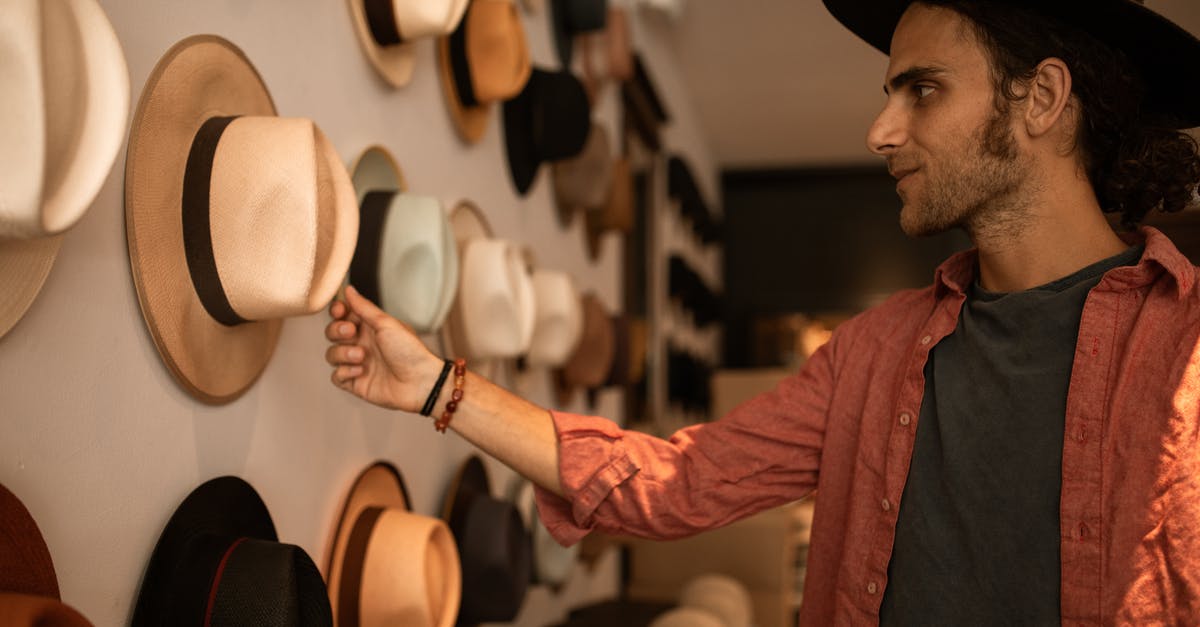 Winning outfits instead of buying them - Man in Red Dress Shirt and Black Cowboy Hat Winning outfits instead of buying them - Man in Red Dress Shirt and Black Cowboy Hat