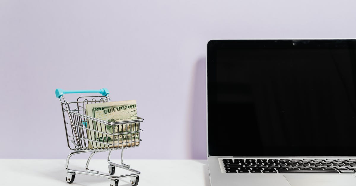 Words with friends, endgame regarding blanks? - Macbook Pro on White Table Beside a Miniature Shopping Cart With Money