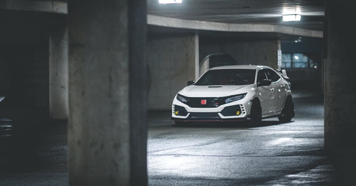 Would installing a solid state drive improve my load time in Rainbow 6: Siege? [duplicate] - Contemporary white automobile driving on shiny floor illuminated by glowing ceiling lamps in car park with cement posts in evening