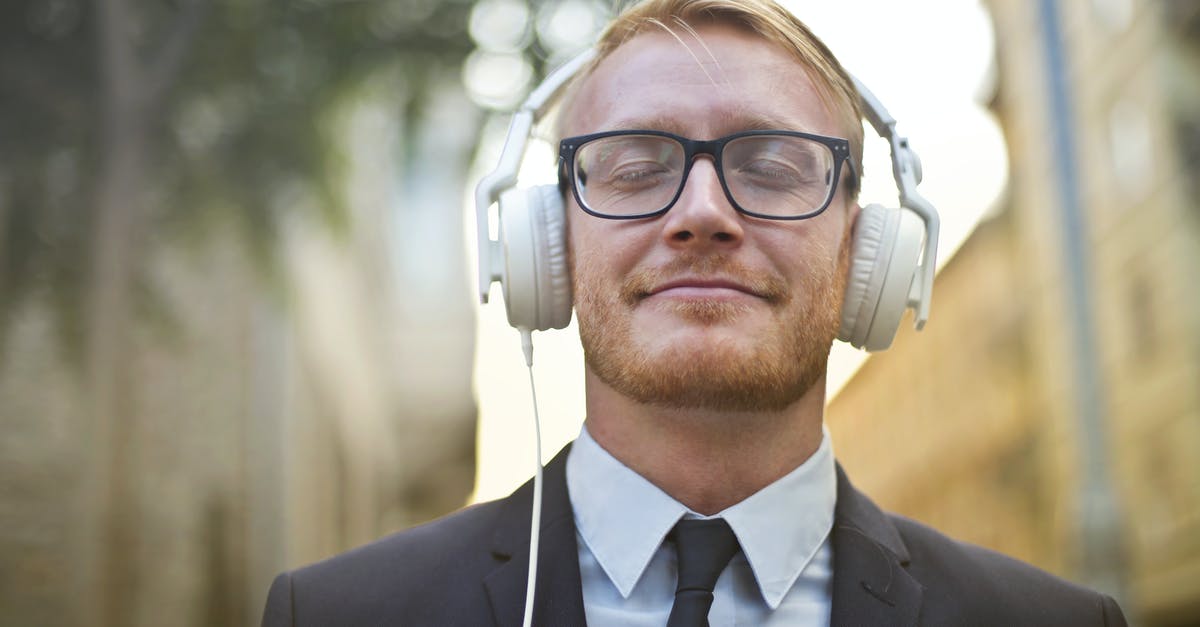 Xbox 360 game sound through headset - Cheerful man in formal wear enjoying music Xbox 360 game sound through headset - Cheerful man in formal wear enjoying music