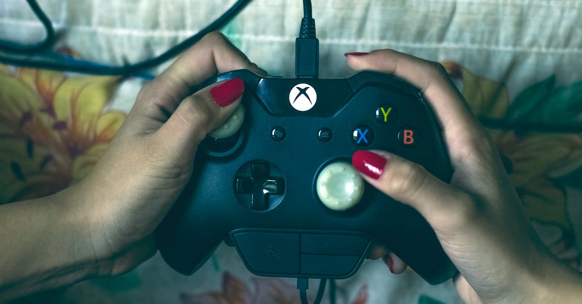 Xbox 360 Steering Wheel on Xbox One - Person Holding Microsoft Xbox One Controller Xbox 360 Steering Wheel on Xbox One - Person Holding Microsoft Xbox One Controller