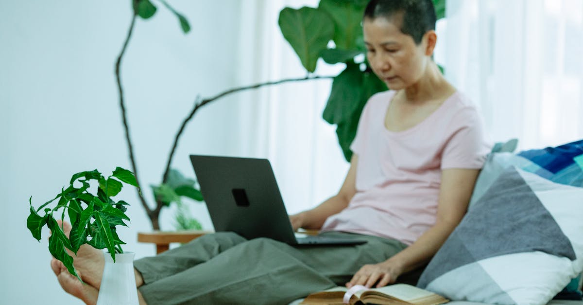 Xbox live gamertag recovery - Full body of focused adult ethnic female freelancer with dark short hair in casual clothes working remotely on laptop while sitting on sofa at home Xbox live gamertag recovery - Full body of focused adult ethnic female freelancer with dark short hair in casual clothes working remotely on laptop while sitting on sofa at home