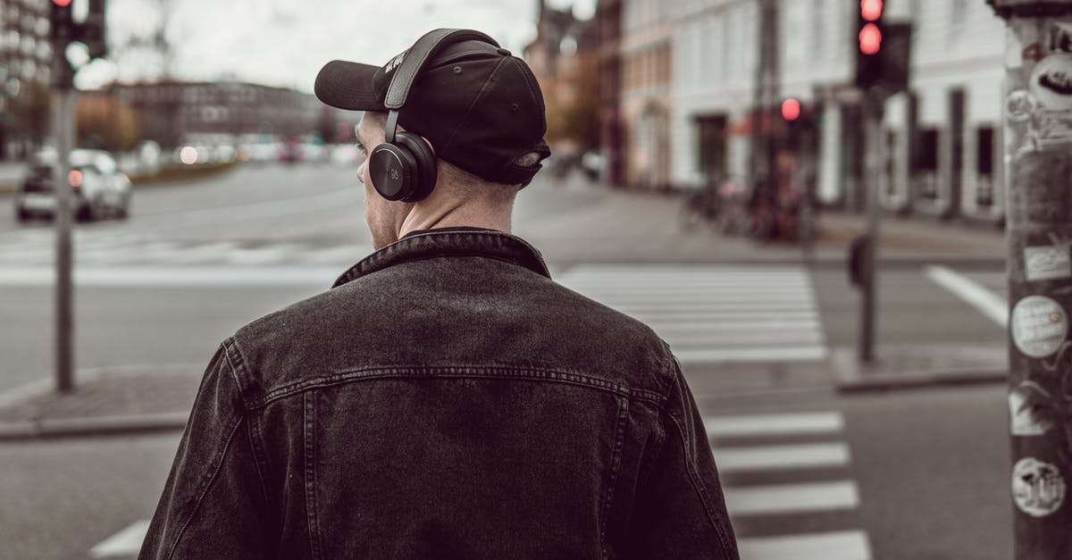 Xbox one X - surround with stereo headphones is possible - Man listening to music on city street