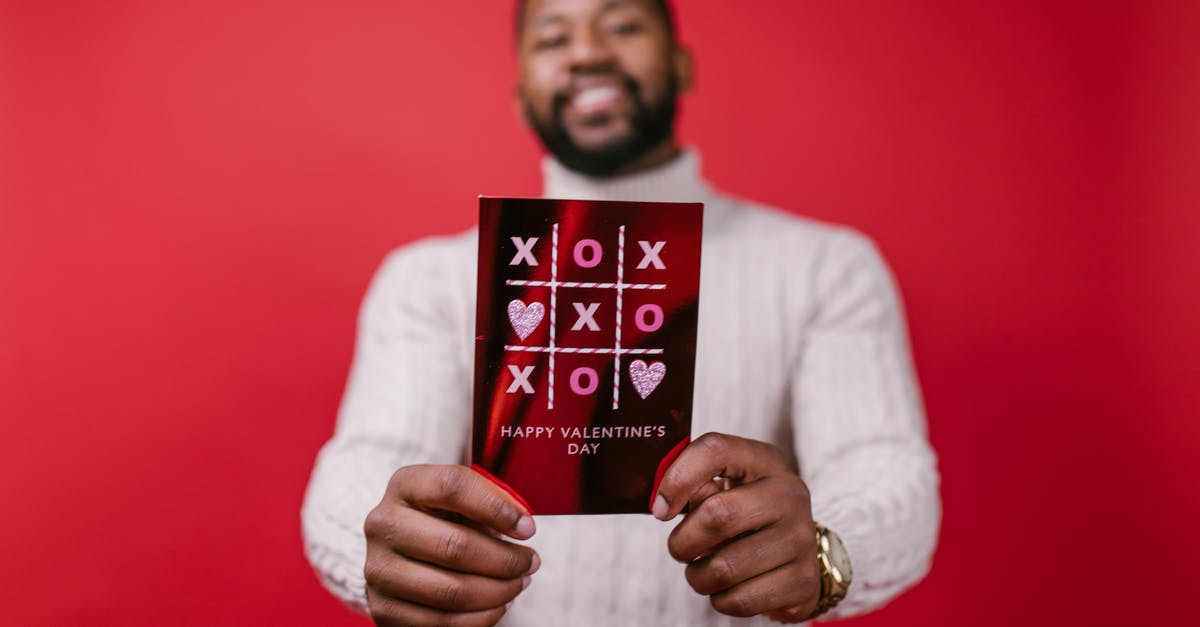 Zenyatta's Orb of Discord and Reinhardt's shield - Man in White Long Sleeve Shirt Holding Valentine's Day Card