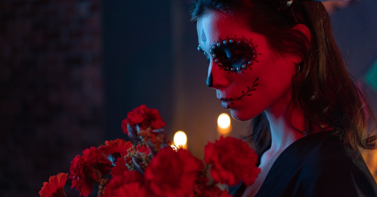 Zombie Head Common or Rare Classification? - Woman with Scary Makeup Looking at Red Flowers Zombie Head Common or Rare Classification? - Woman with Scary Makeup Looking at Red Flowers